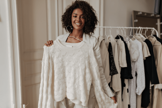 Consignment Stores Woman Holding Sweater
