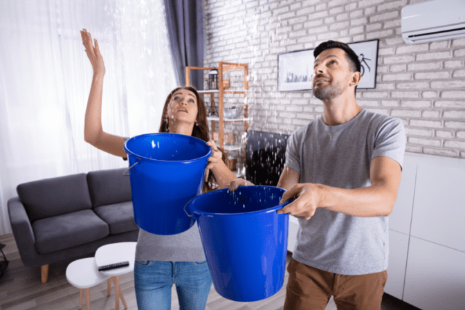 Hoarding 3 Years From Now Woman and Man Hold Buckets for Ceiling Leak