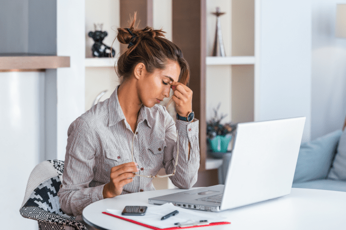It's Okay to Feel Bad about Hoarding Woman With Headache on Computer